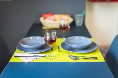 a table with two plates and a glass of wine at Let me Athens you! #3 in Athens
