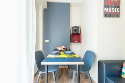 a dining room with a blue table and chairs at Let me Athens you! #3 in Athens