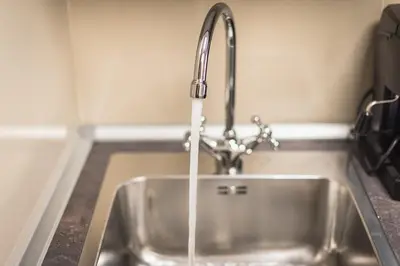 a kitchen sink with water coming out of a faucet at Let me Athens you! #3 in Athens