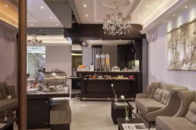 a lobby with couches and a chandelier at Ava Hotel and Suites in Athens
