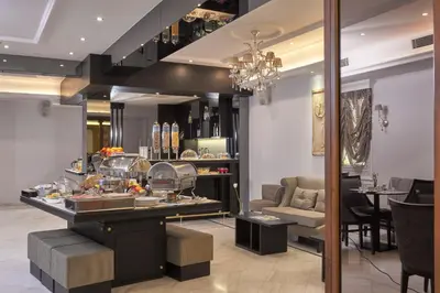 a restaurant with a counter with food on it at Ava Hotel and Suites in Athens