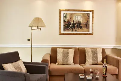 a living room with a couch and a painting on the wall at Ava Hotel and Suites in Athens