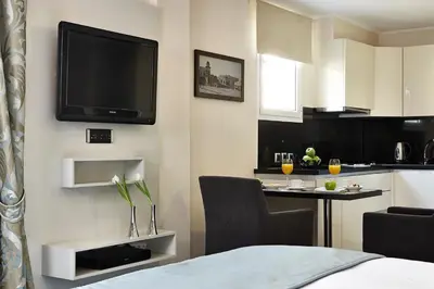 a room with a bed and a tv on a wall at Ava Hotel and Suites in Athens