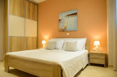 a bedroom with a large bed with white pillows at Alimos Modern Retreat, near the beach in Athens