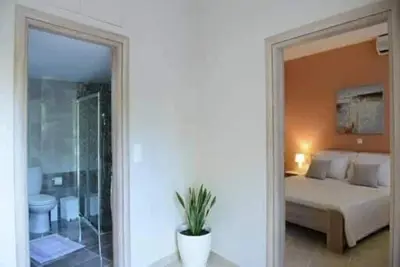 a bedroom with a bed and a bathroom with a shower at Alimos Modern Retreat, near the beach in Athens