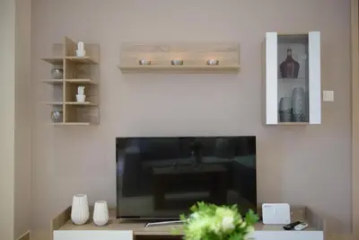 a living room with a large flat screen tv at Alimos Modern Retreat, near the beach in Athens