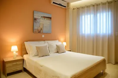 a bedroom with a large bed with white pillows at Alimos Modern Retreat, near the beach in Athens