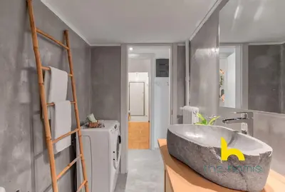a bathroom with a large bath tub in a room at Lush island-style hideaway in lively Koukaki! in Athens
