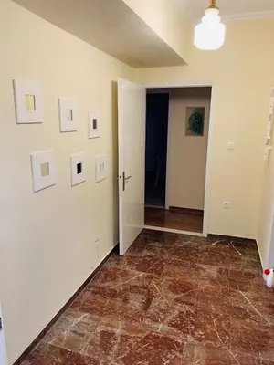an empty living room with a tile floor and white walls at Small Apartment in Markopoulo center in Markopoulo
