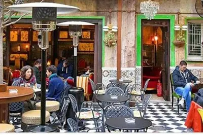 a group of people sitting at tables in a restaurant at Purple- Lux studio 2' from metro Petralona in Athens