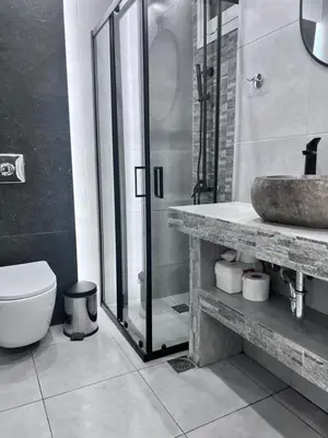 a bathroom with a shower and a toilet and a sink at Purple- Lux studio 2' from metro Petralona in Athens