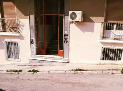 a front door of a building with a fan at Purple- Lux studio 2' from metro Petralona in Athens
