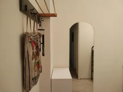 a hallway with a table and a mirror in a room at Archelaou Street Living in Athens