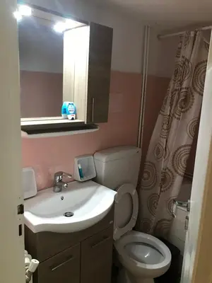 a bathroom with a sink and a toilet and a mirror at Archelaou Street Living in Athens