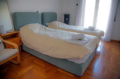 a bedroom with two beds with towels on them at Cathedrals square supreme residence in Athens