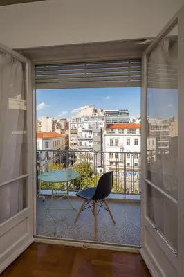 a room with a view of a city from a window at Cathedrals square supreme residence in Athens
