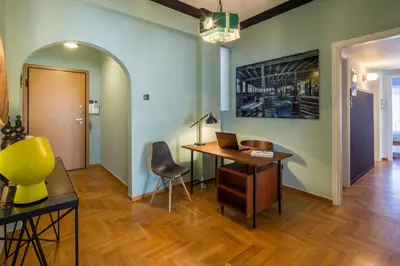 an office with a desk with a laptop and a chair at Cathedrals square supreme residence in Athens