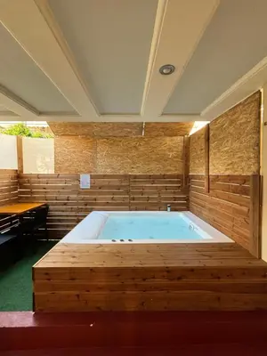 a jacuzzi tub in a room with a table at Jacuzzi studio close to athens airport!! in Pallíni