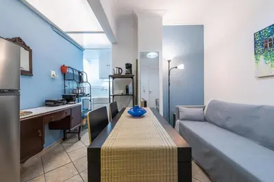 a living room with a table and a couch at Splash of Glam III 10 steps from Acropolis in Athens