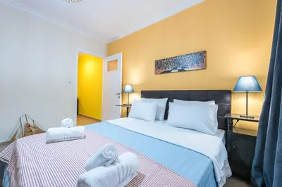 a hotel room with two beds with towels on them at Splash of Glam III 10 steps from Acropolis in Athens