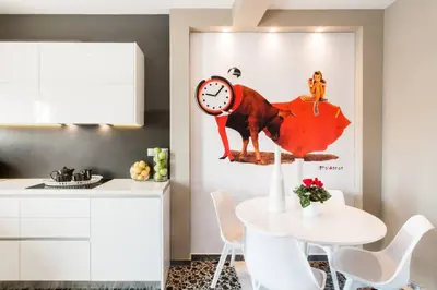a kitchen with a table and a clock on the wall at Ma Maison No1 Penthouse, Acropolis view, 315 Mbps in Athens
