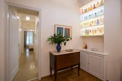 a hallway with a table with a vase on it at 