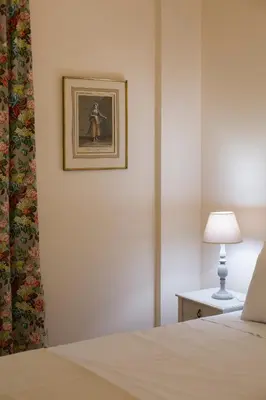 a bedroom with a bed and a picture on the wall at 
