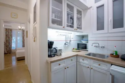 a kitchen with white cabinets and a sink at 