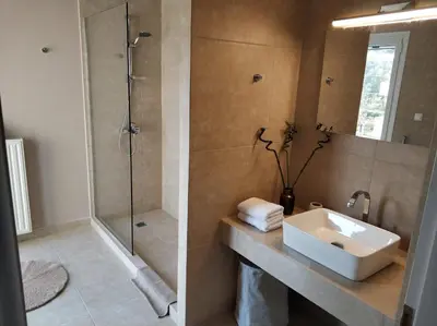 a bathroom with a sink and a shower at Relaxing Villa with Swimming Pool and Garden in Áyios Yeóryios