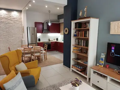 a living room and a kitchen with a dining room at Central & Comfortable, 70m² Apt in Neos Kosmos in Athens