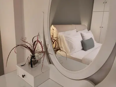 a mirror reflecting a bedroom with a bed and a pillow at Central & Comfortable, 70m² Apt in Neos Kosmos in Athens