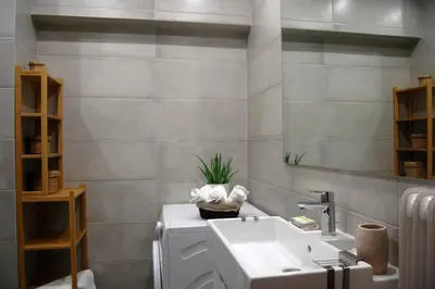 a bathroom with a sink and a toilet with a plant on it at Central & Comfortable, 70m² Apt in Neos Kosmos in Athens