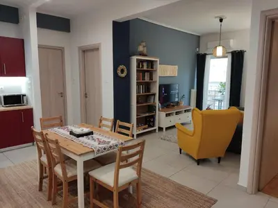 a kitchen and dining room with a table and chairs at Central & Comfortable, 70m² Apt in Neos Kosmos in Athens
