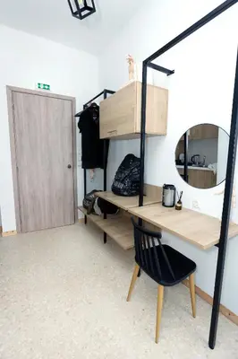 a desk and a chair in a room with a mirror at Old Town Hall Suites and Apartments in Athens