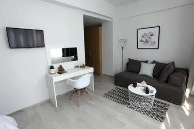 a small living room with a couch and a table at Old Town Hall Suites and Apartments in Athens