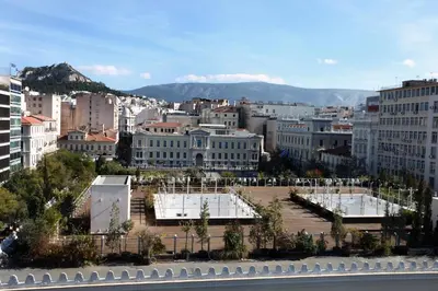 a view of a city with mountains in the background at Old Town Hall Suites and Apartments in Athens