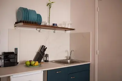 a kitchen with a sink and a bowl of fruit at Mosaics aprtm in the historical center of Athens Ermou 18 in Athens
