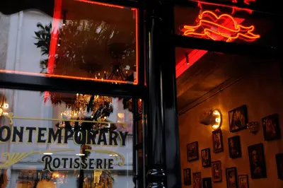 a sign in the window of a restaurant at Mosaics aprtm in the historical center of Athens Ermou 18 in Athens