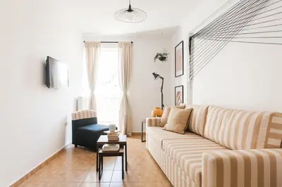 a living room with a couch and a table at Boho House with Acropolis View! in Athens