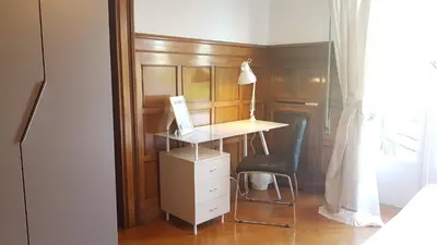 a desk with a laptop and a chair in a room at Violet Errathens Apartment - Athens Center, 7 BD, 3 BATH in Athens