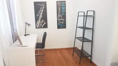 a desk with a computer and a shelf with a saxophone at Violet Errathens Apartment - Athens Center, 7 BD, 3 BATH in Athens