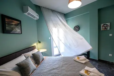a bedroom with a bed with two towels on it at Smart renovated studio downtown Athens in Athens