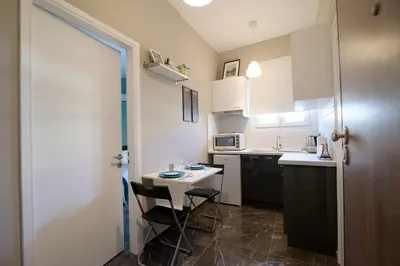a small kitchen with a small table and chairs at Smart renovated studio downtown Athens in Athens