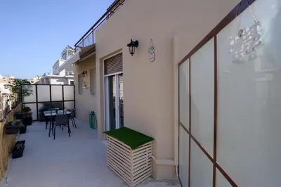 a balcony of a building with a bench on it at Smart renovated studio downtown Athens in Athens