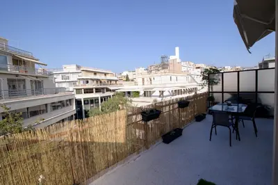 a balcony with a table and some buildings at Smart renovated studio downtown Athens in Athens