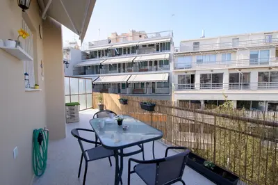 a balcony with a table and chairs and a building at Smart renovated studio downtown Athens in Athens
