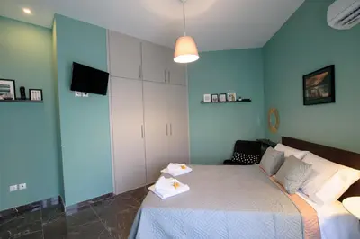 a bedroom with a bed with two towels on it at Smart renovated studio downtown Athens in Athens