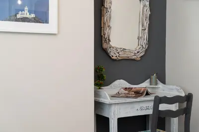 a room with a table and a mirror on the wall at Athens Flower Apartment in Athens