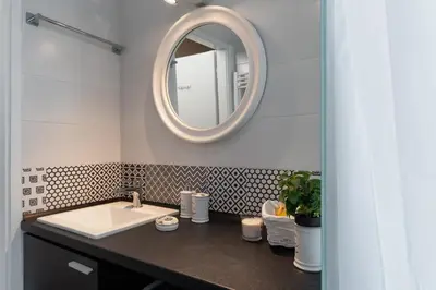 a bathroom with a sink and a mirror at Athens Flower Apartment in Athens