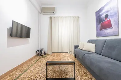 a living room with a couch and a tv at Athens Oasis in Athens